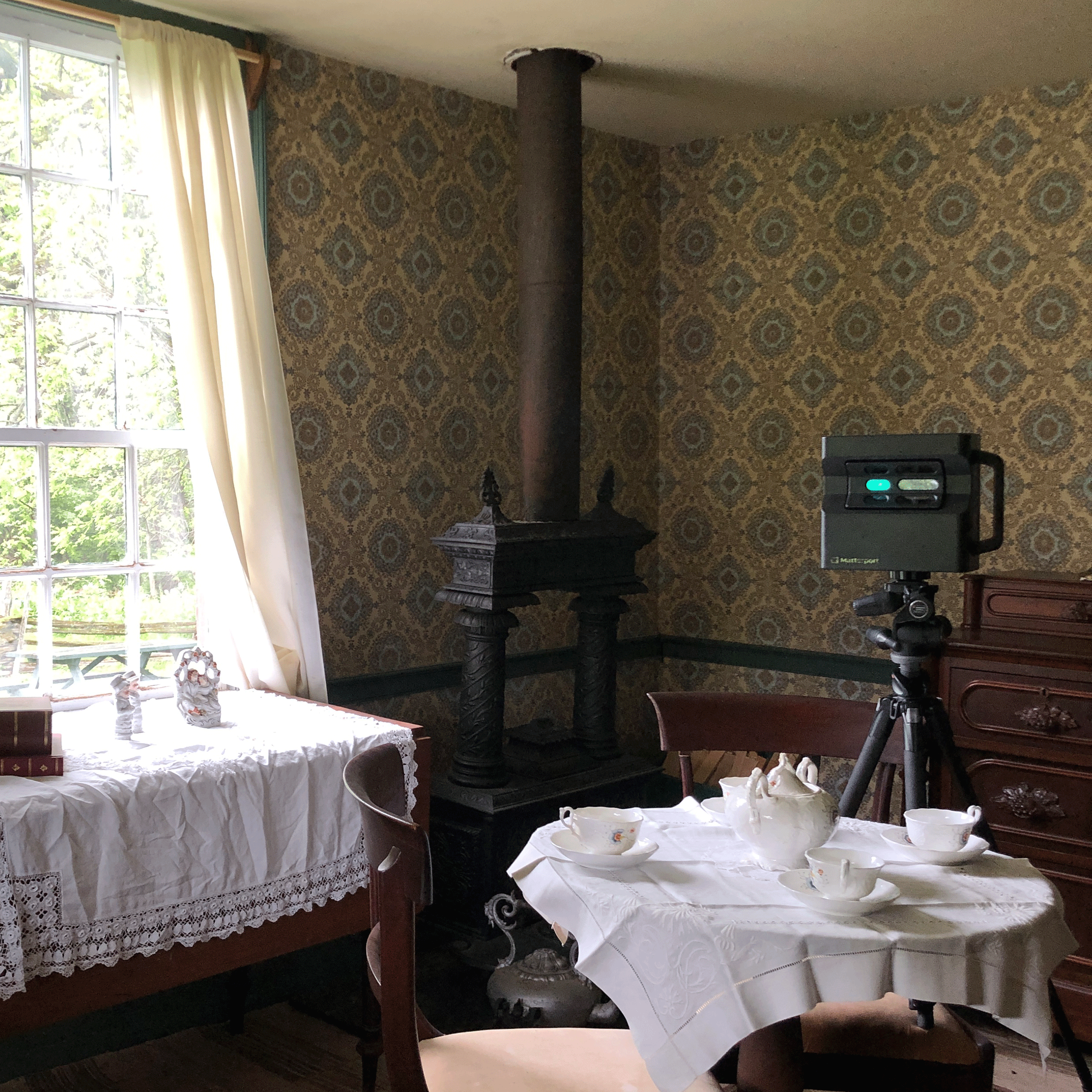 Matty The Matterport Pro2 Camera sitting at a old fashioned dining table in a museum